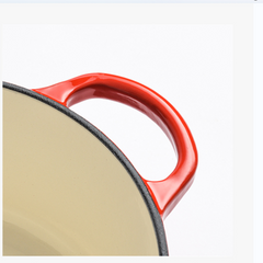 Close-up of a red-handled frying pan on a white background