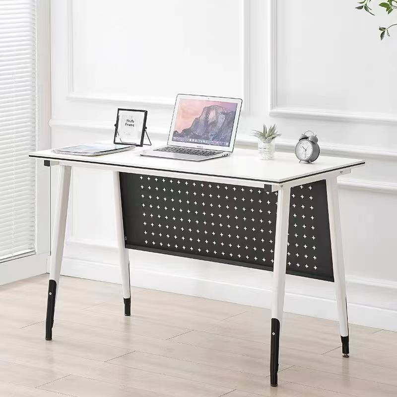 White desk with star-patterned backrest in a room with windows and a plant.