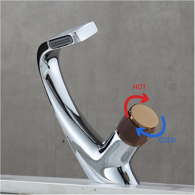 A chrome faucet with a single handle, marked with 'HOT' and 'COLD' indicators for temperature control.