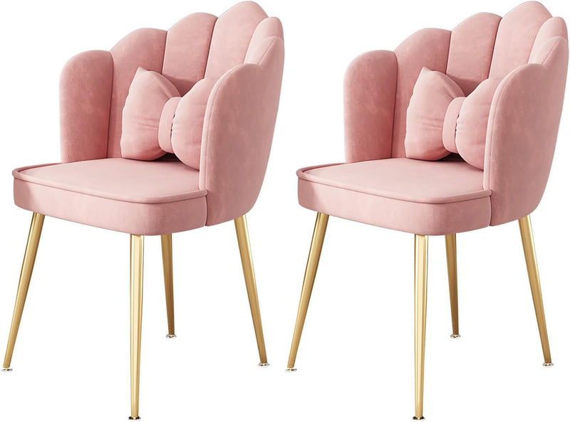 A pair of pink velvet living room chairs with upholstered backrest and seat, featuring gold metal legs.