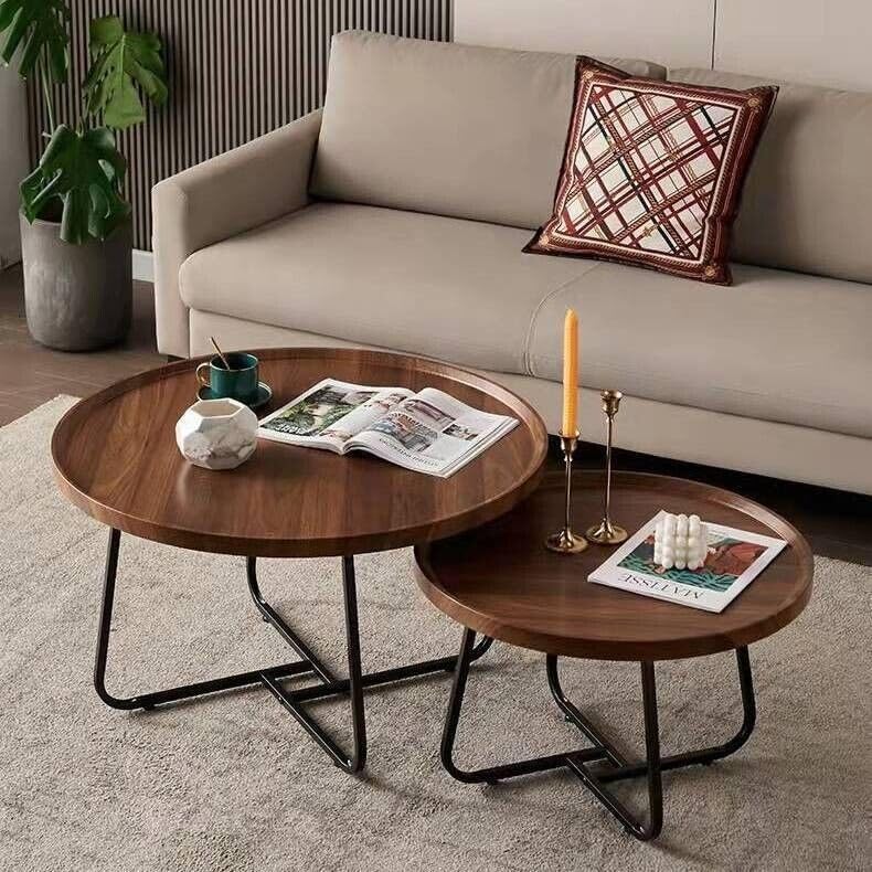 Two wooden coffee tables with decorative items in a living room setting.
