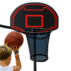 Child holding a basketball aiming to shoot at a basketball hoop with a clear blue sky background