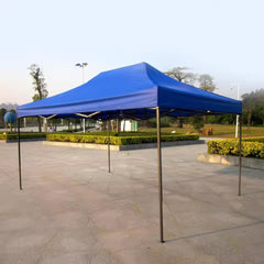 Blue canopy tent on a stone pavement with greenery in the background